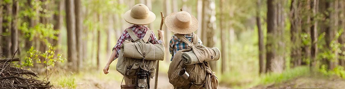 Kids trekking through forest (Photo by Shutterstock)